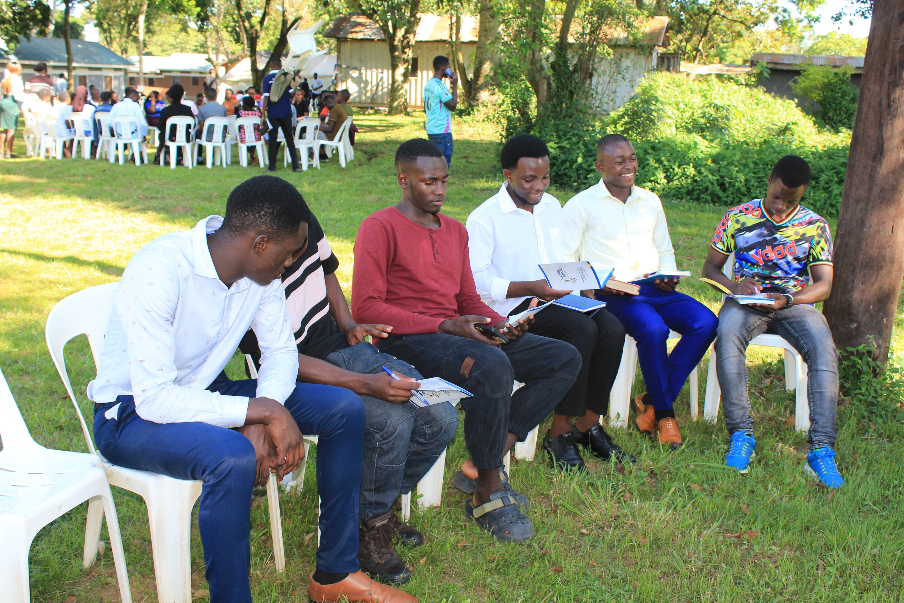 Students seated outdoors in a small-group session at a FOCUS conference